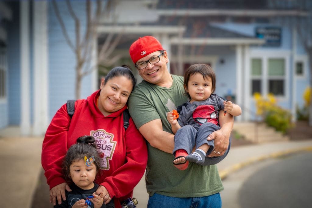 Residents Paul and Jade, with their children in front of Wagner Hall at the Grants Pass Gospel Rescue Mission